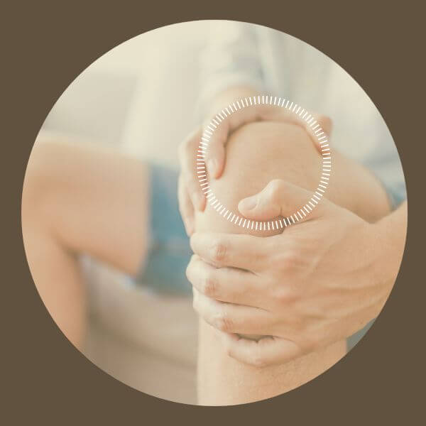 view of persons hands holding sore knee